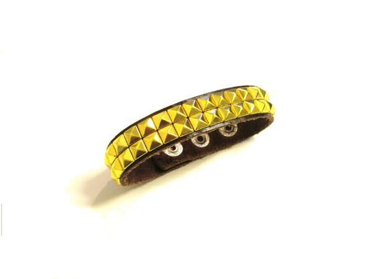 Dark brown bracelet with gold colored rivets