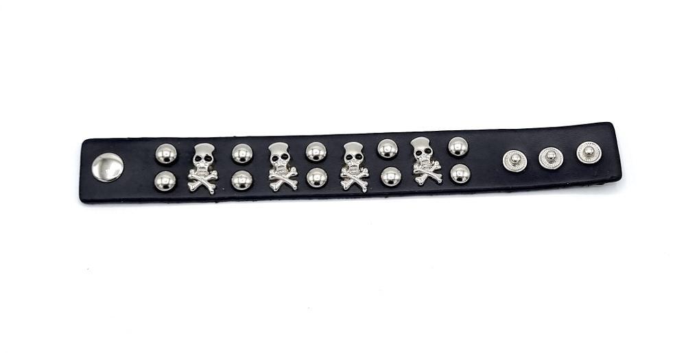 Rivet bracelet with silver colored round rivets and skulls